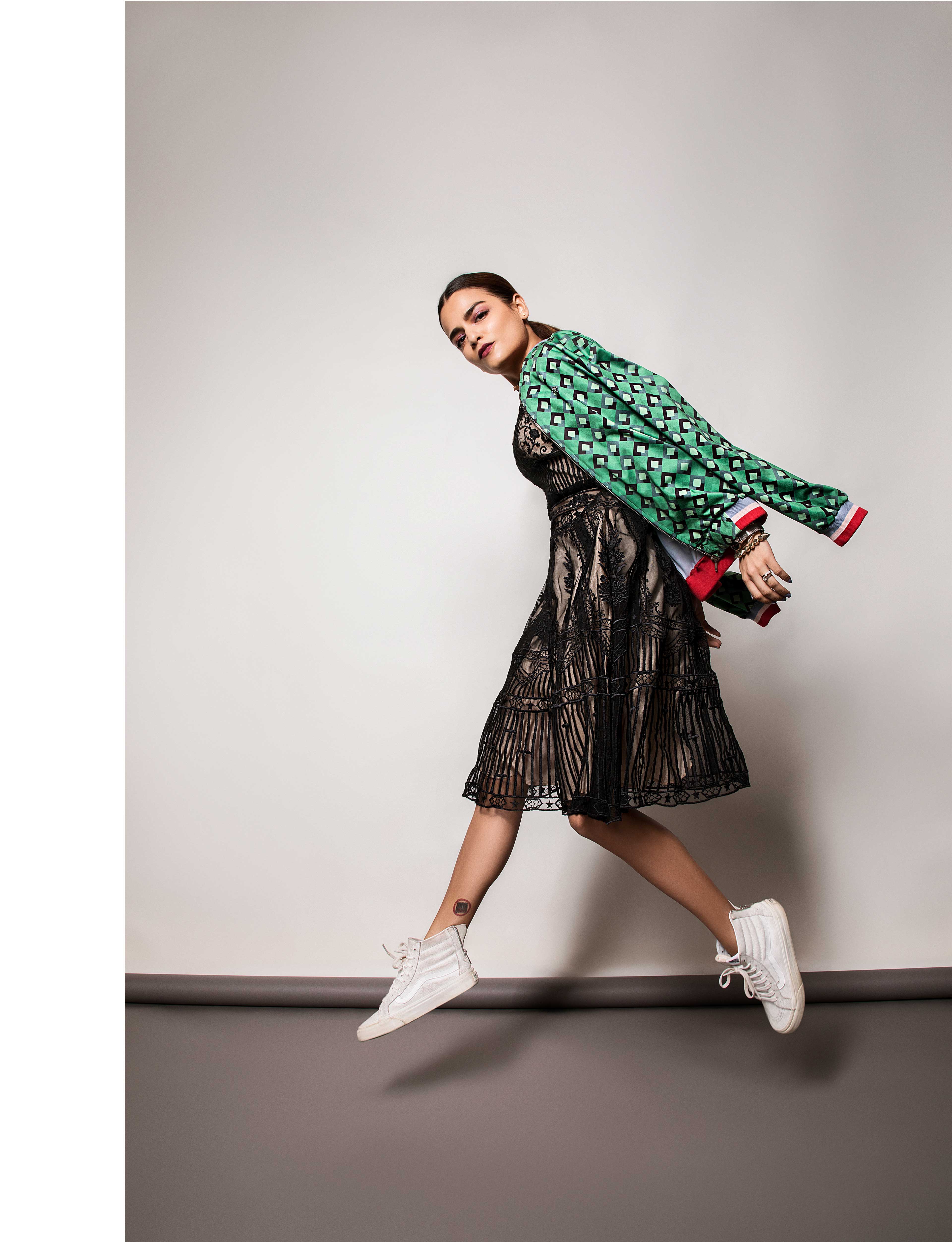 checkered printed bomber jacket along with a pair of chunky trainers