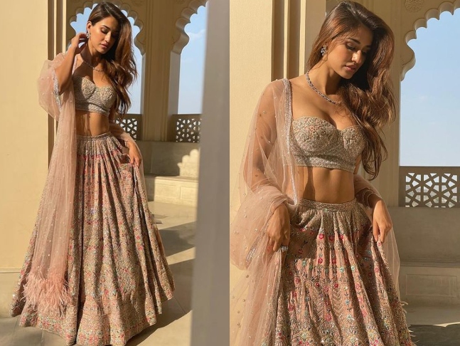 Falguni Shane Peacock Lehenga is hand-crafted with intricate embroidery in multicolored silk threads.