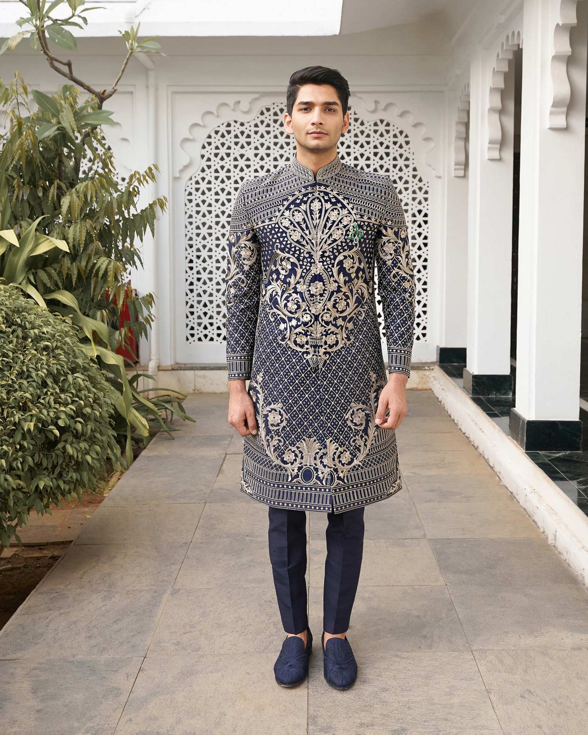 midnight blue is crafted with intricate embroidered details in metal threads