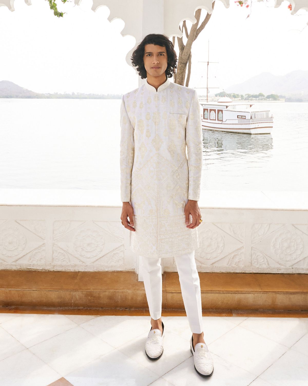 The Falguni Shane Peacock Sherwani for men is intricately embroidered with raw silk threads