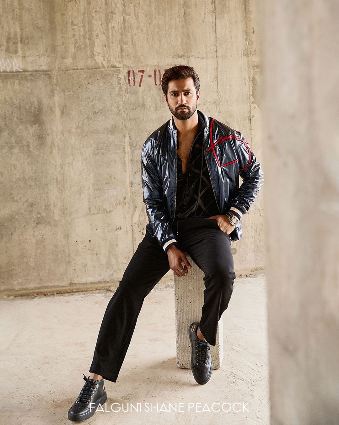 A bomber jacket paired with a shirt and trousers
