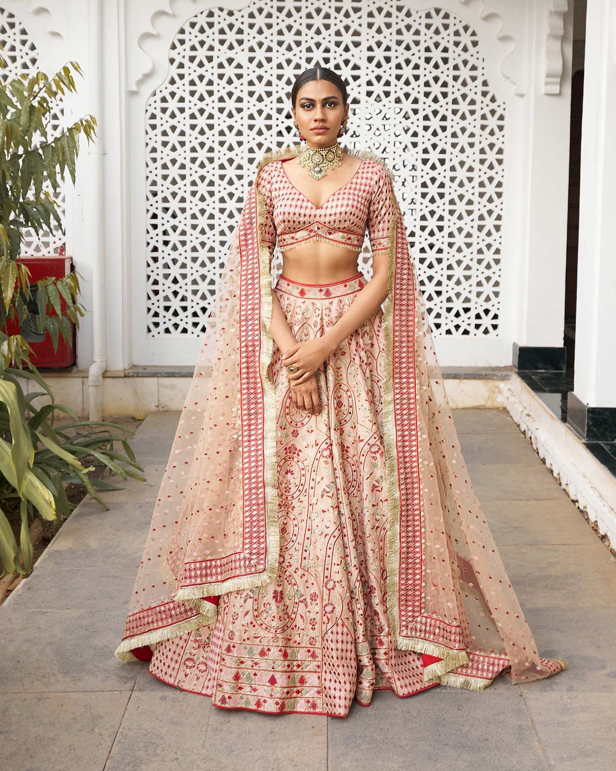 A peach Indian Lehenga crafted with intricate floral and foliage embroidered
