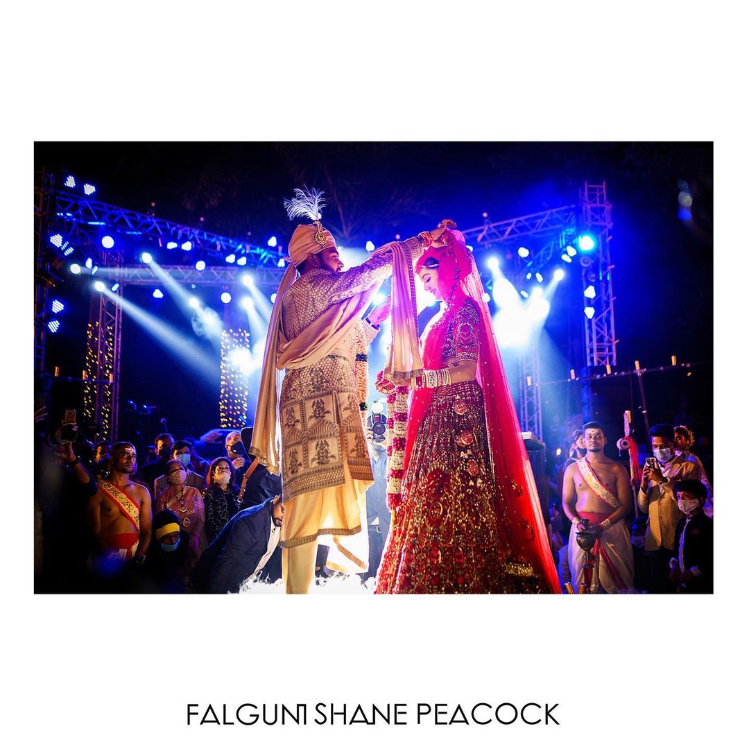 A Falguni Shane Peacock bride donning a bespoke, royal red bridal Lehenga