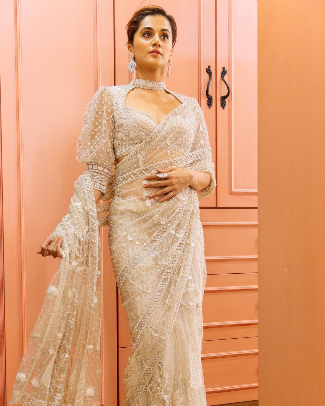 Tapsee Pannu opted for a silver encrusted saree by the designers