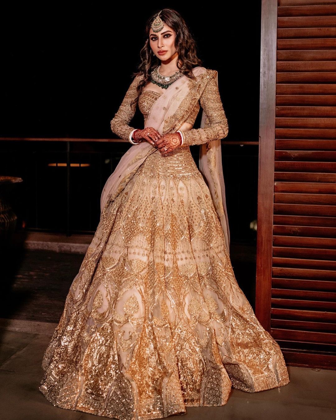 Mouni Roy in a light pink-based, golden Falguni Shane Peacock Lehenga