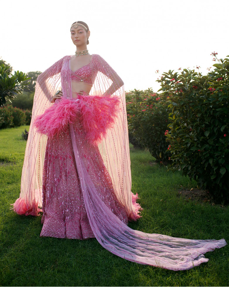 BUBBLE-GUM PINK LEHENGA HANDCRAFTED WITH SEQUINS DETAILING AND A FEATHERED BOW.