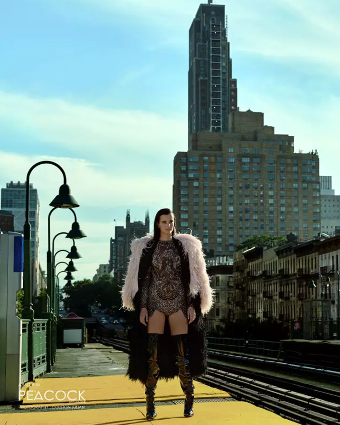 BLACK BODYSUIT WITH A BLACK FEATHERED TRENCH COAT AND PEACH FEATHERED SHRUG