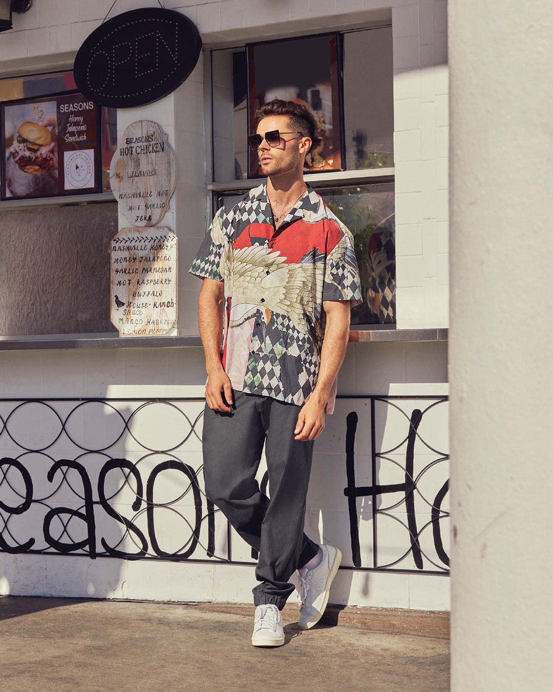 Multicoloured, printed half-sleeve shirt, styled with a pair of slate grey joggers 