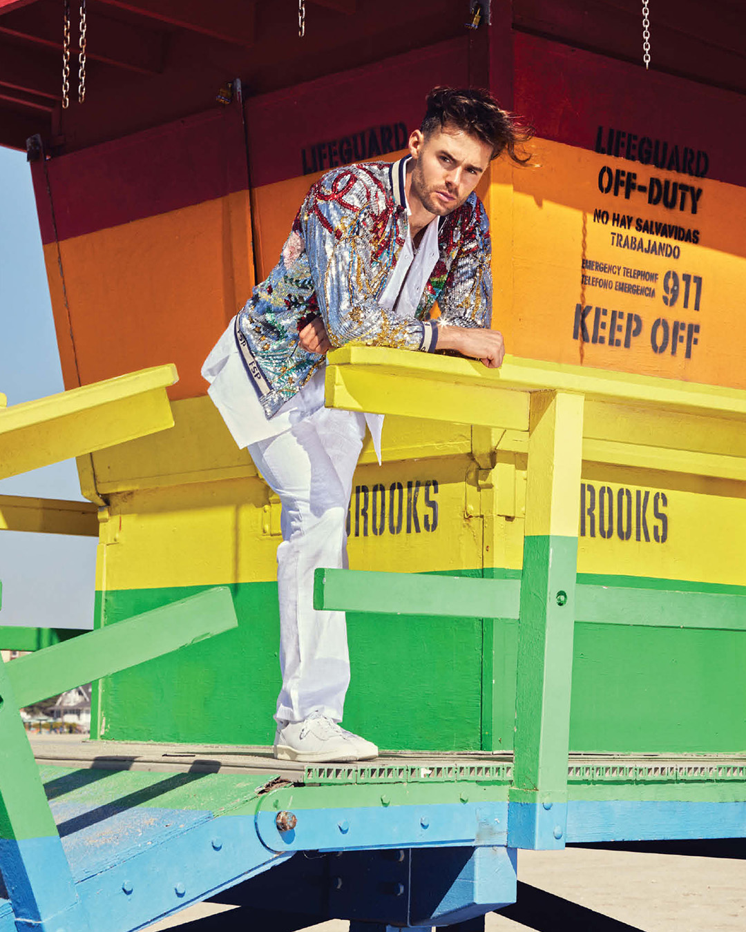 White co-ord set styled with a multicoloured sequinned bomber jacket 