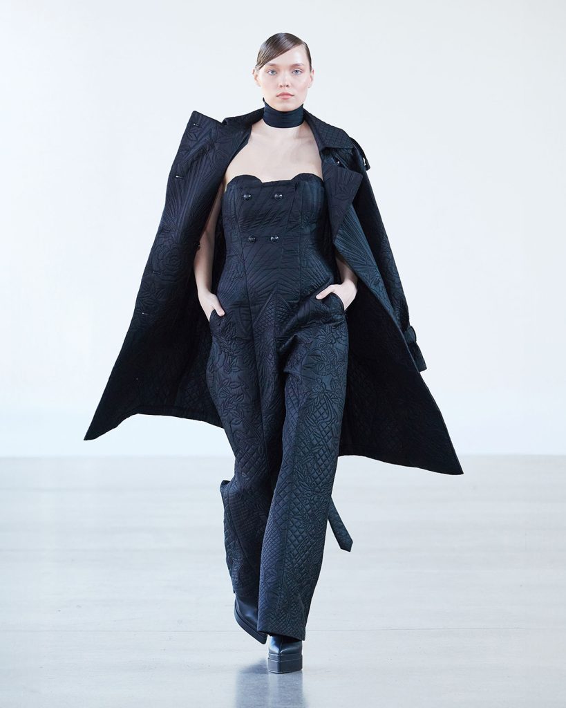 Black quilted jumpsuit with trench coat