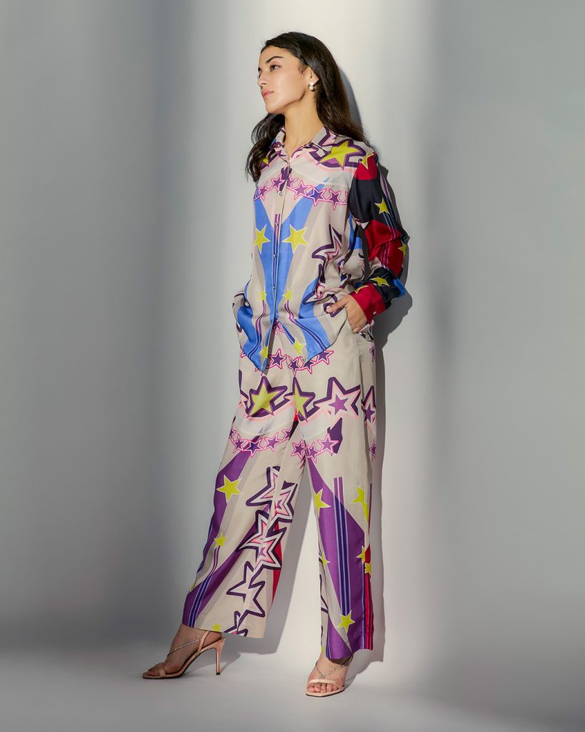 Model in star print button-down shirt and trouser co-ord set