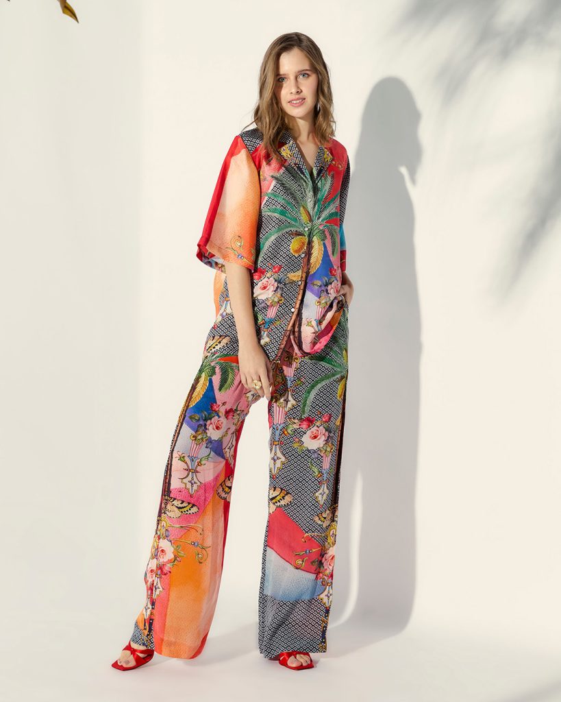Woman wearing a colourful tropical print short-sleeve trouser set